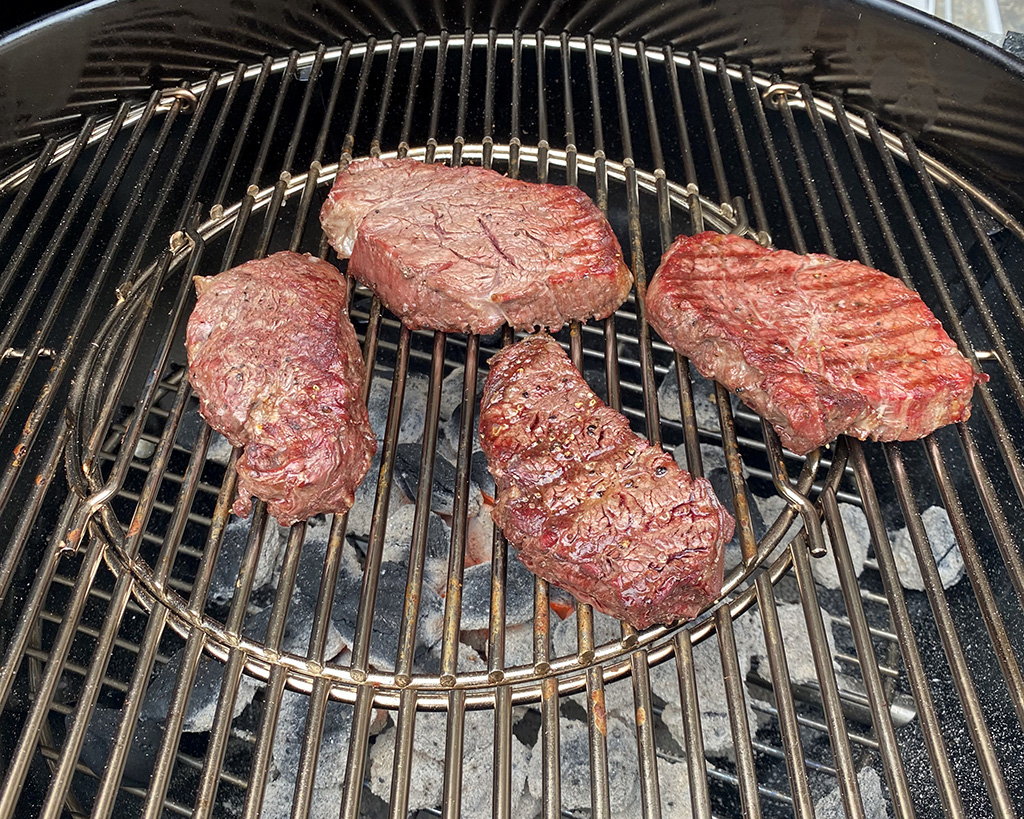 Weber Performer Deluxe with steaks on the grill