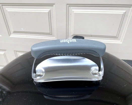 Grill lid handle on the top lid of the Weber 22 in. Performer Deluxe