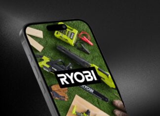 A smart phone against a background. On the phone screen displays the RYOBI app with a picture of various RYOBI power tools and OPE, with the RYOBI logo in the center.