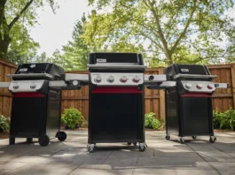 Three new 2025 Weber Spirit models side-by-side on a patio in a backyard on a warm spring day. From left to right is a two-burner, a four-burner, and three-burner 2025 Weber Spirit models