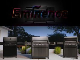 Monument Grills launches new flagship Eminence Series smart gas grills. In this pic is the E405 on a patio in a backyard with evergreens in the background.