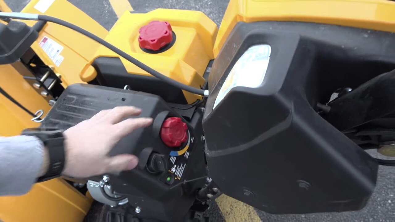Hand at the starting controls of the Cub Cadet 2X EFI