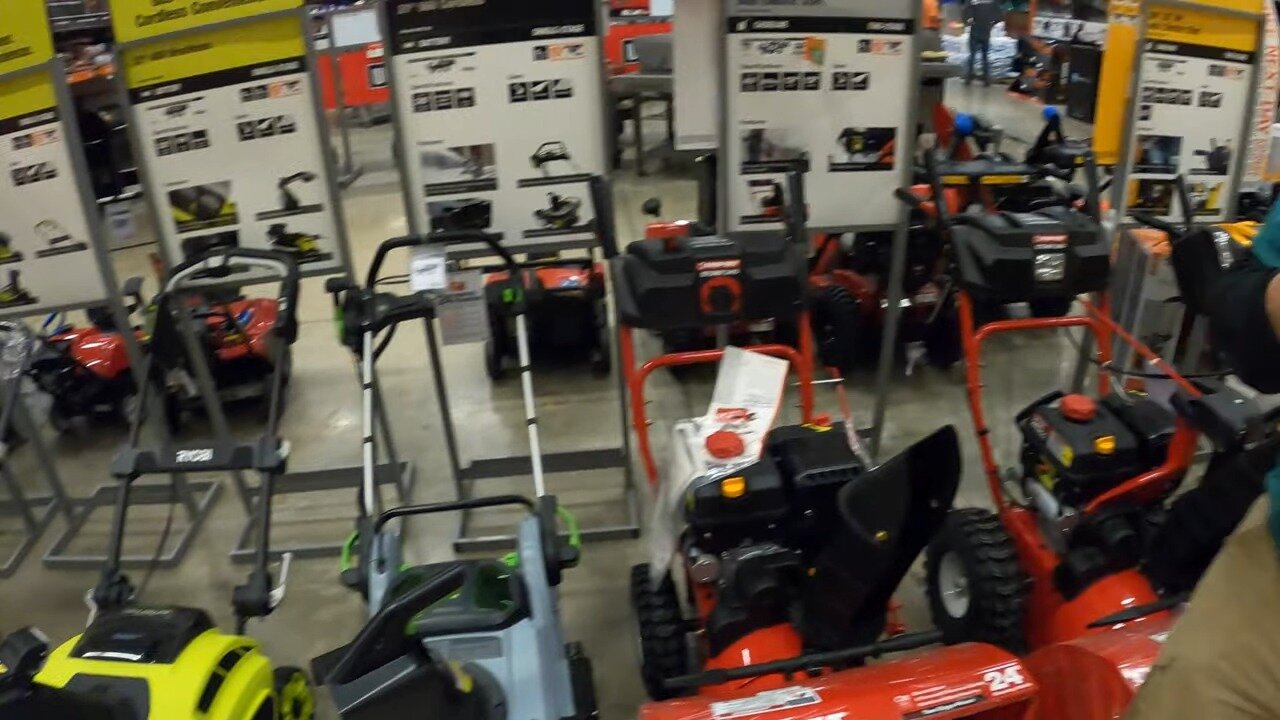 Two-stage snow blowers lined up in the Home Depot aisle
