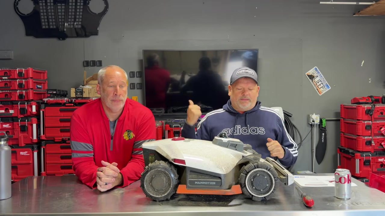 Dan and his co-host at the shop table with the Mammotion LUBA 3 AWD robot mower
