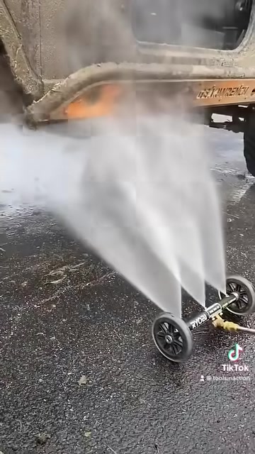 RYOBI pressure washer water broom nozzles spraying upward under a vehicle