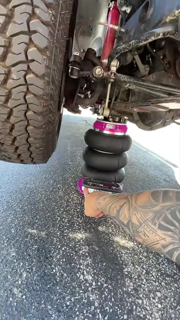 RakJak air jack lifting a truck under the front suspension