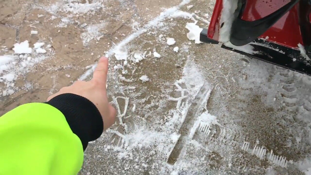 Pointing at the plastic scraper along the bottom of the Toro 724 QXE