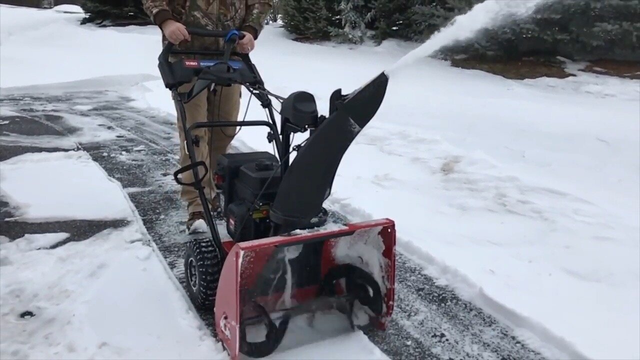 Toro 724 QXE clearing a path through packed snow