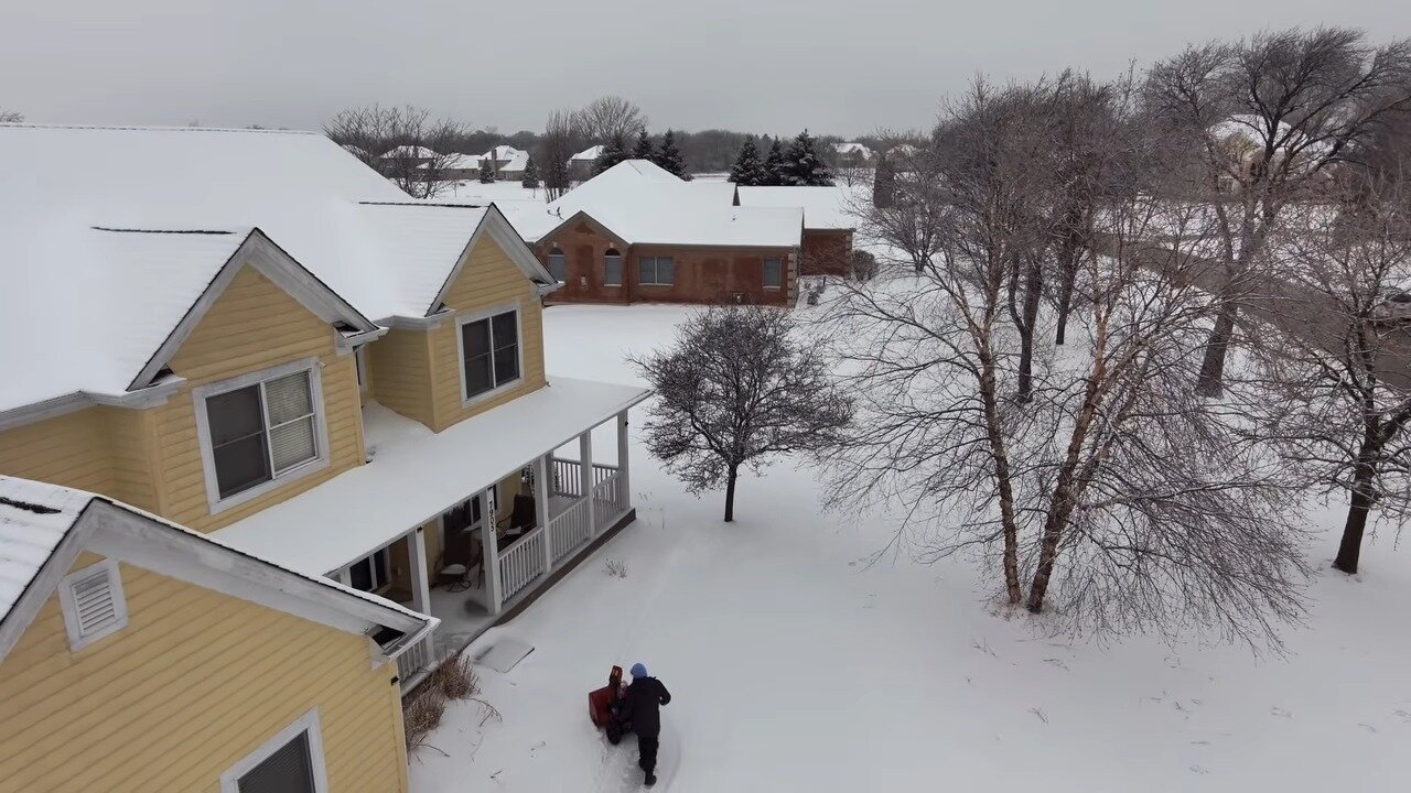 Snow covered yard and driveway in the Chicago suburbs
