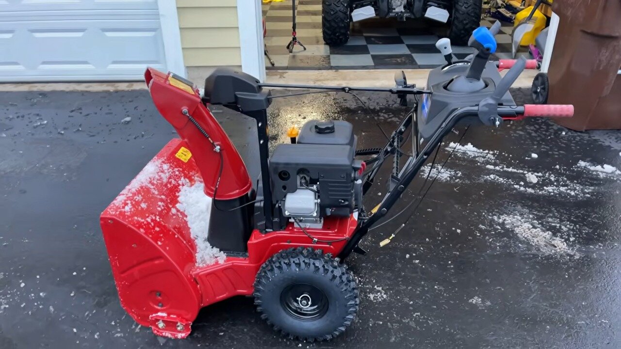 TORO Power Max 826 OHAE snow blower parked on a wet driveway