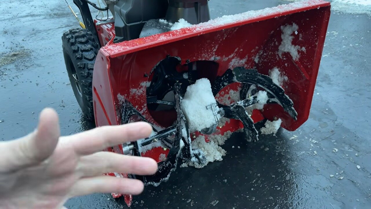 Pointing out the auger and shear pins on the TORO Power Max 826 OHAE
