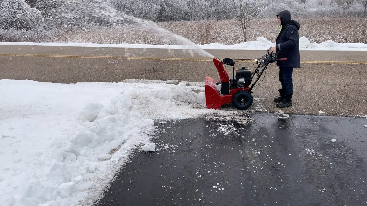 TORO Power Max 826 OHAE throwing snow on a driveway