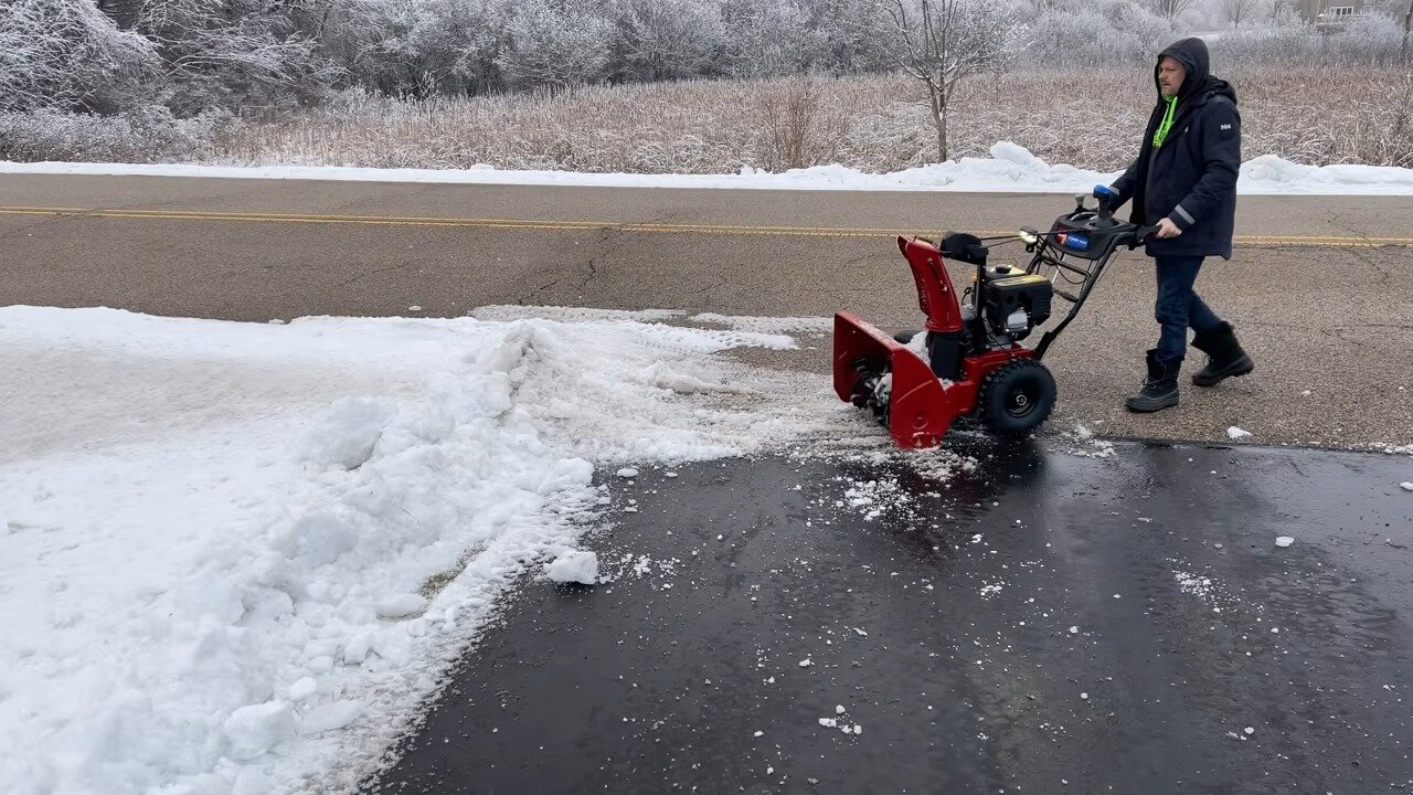 Clearing snow along a driveway with the TORO Power Max 826 OHAE
