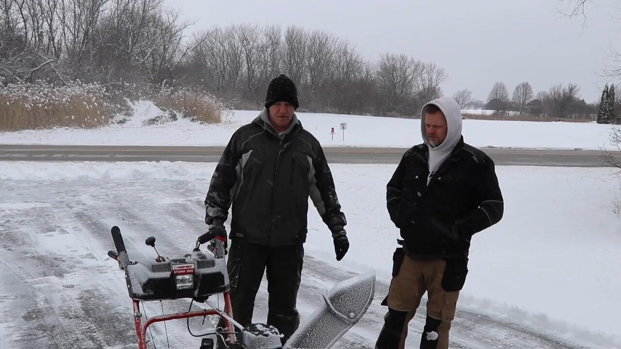 Host and neighbor with a Troy Bilt snow thrower on a snowy driveway